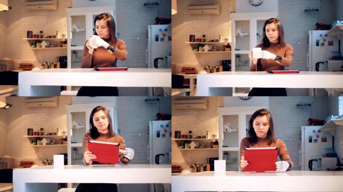 年轻女子正在用合成手从杯子里喝水