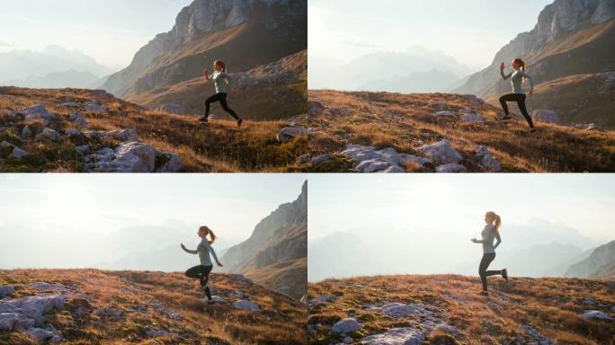 健康的女运动员保持健康的生活方式，在日落时分在多岩石的小径和草坡上奔跑