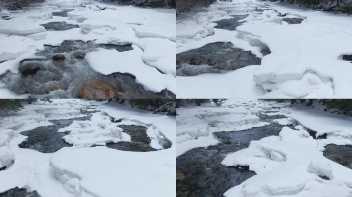 特写: 森林溪流在穿越白雪皑皑的风景时飞溅。