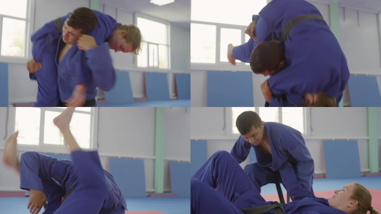 男性战士在练习柔术时将女性伴侣扔在垫子上