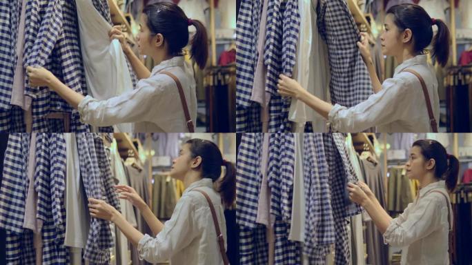 年轻女子在购物中心选择衣服