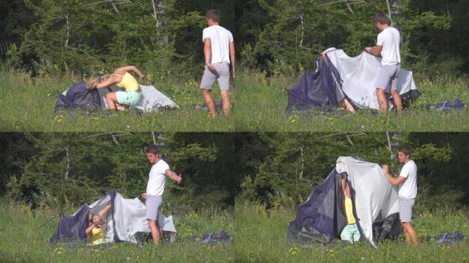 开朗的金发女人在搭帐篷时玩得很开心惹恼她的男朋友。