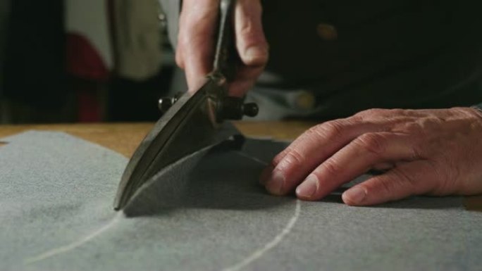 裁缝根据裁缝的传统绘制和切割布料。裁缝师使用完美的针和线来缝制传统概念，