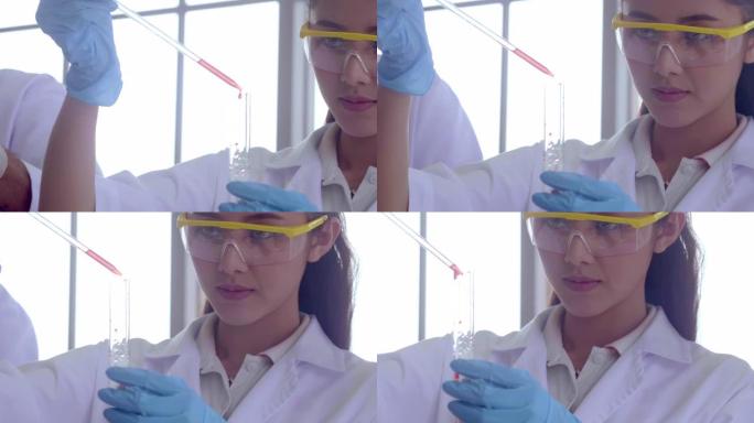 年轻的女化学家滴药水观察器皿