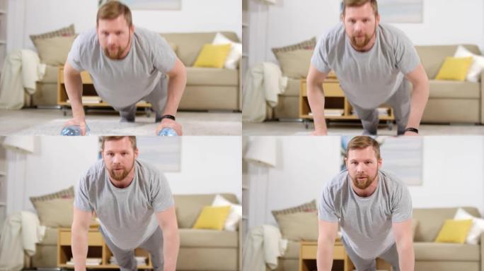 男子在家锻炼时用瓶装水做俯卧撑