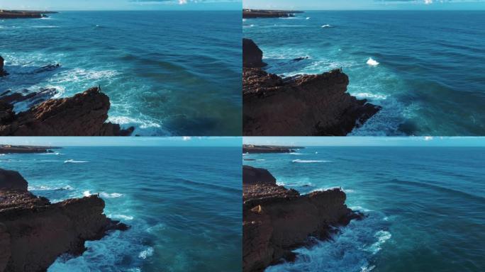 空中无人机镜头: 葡萄牙岩石海岸，海景优美。飞越葡萄牙，海岸线上海浪滚滚，坠入悬崖。孤独的渔夫正在钓