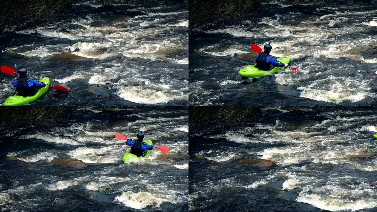 皮划艇男子在野生河上经过