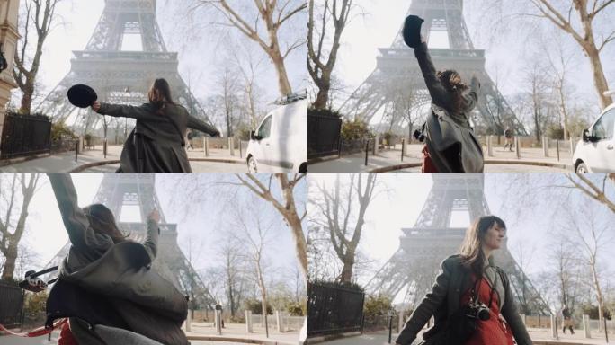 摄像机跟随快乐美丽的女人兴奋地看到著名的埃菲尔铁塔，在巴黎大街上快乐地旋转慢动作
