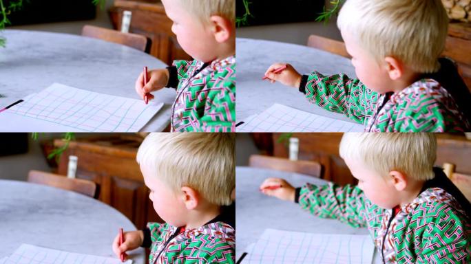 男孩在家用彩色蜡笔在纸上画画4k