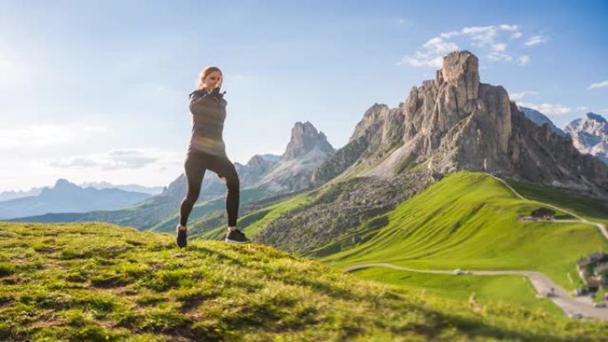 年轻的女运动员在山区的草地上奔跑