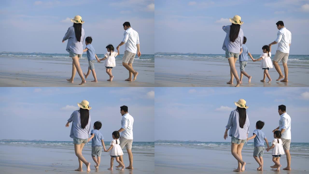 快乐的亚洲家庭在暑假享受和走在海滩上。慢动作。家庭、假期和旅行概念。