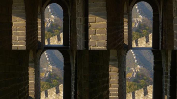特写: 一个石头拱形门口的电影视图，提供长城的视图