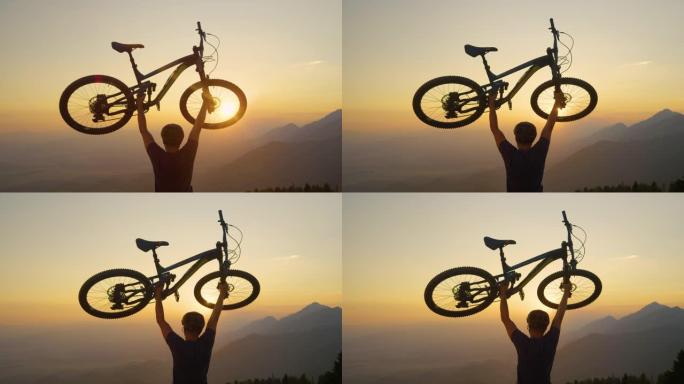 特写: 在金色的日落时分，无法识别的人在空中举起自行车。