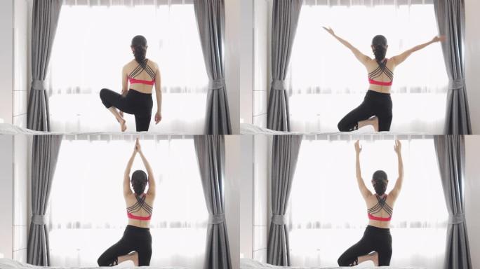 亚洲女性在家练习瑜伽的背面