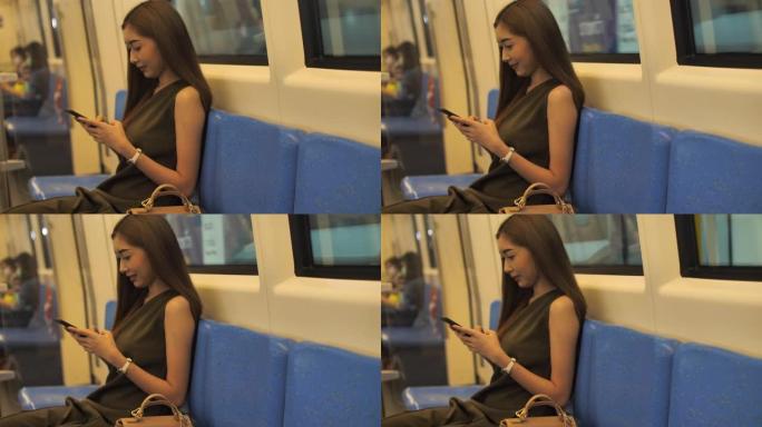 美丽的亚洲女人在地铁列车上使用智能手机上的应用程序