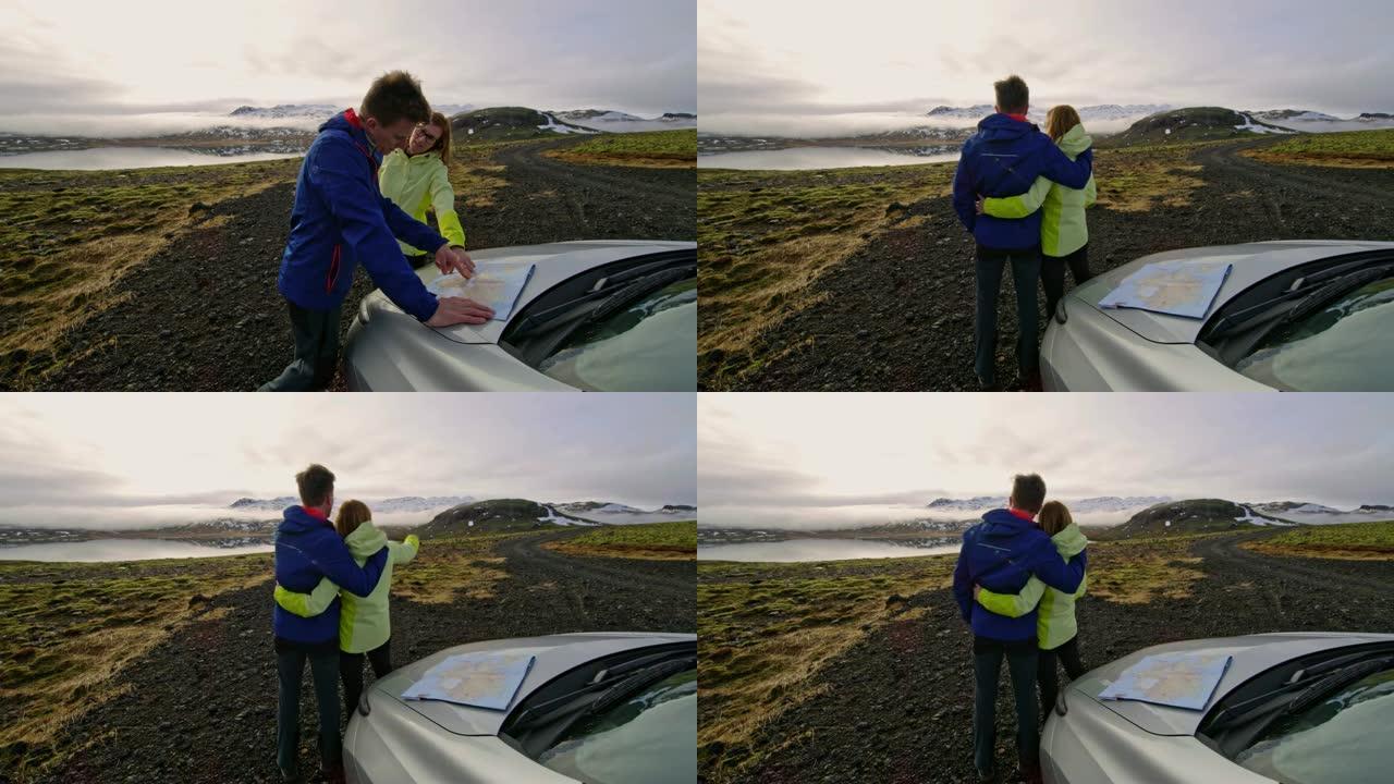 女士深情的夫妇带着地图看着冰岛风景秀丽的偏远景观