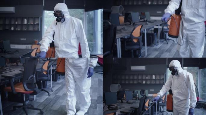 穿着危险品套装消毒办公室的男人