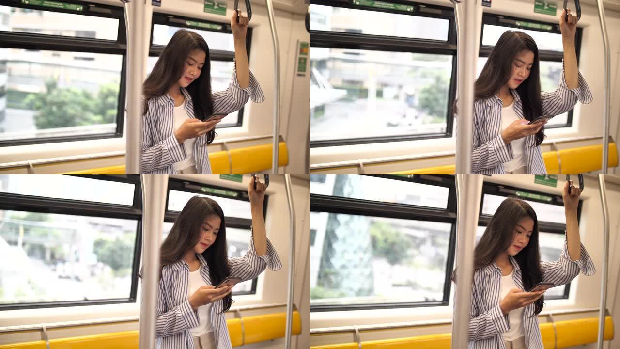 在地铁站使用智能手机的女人