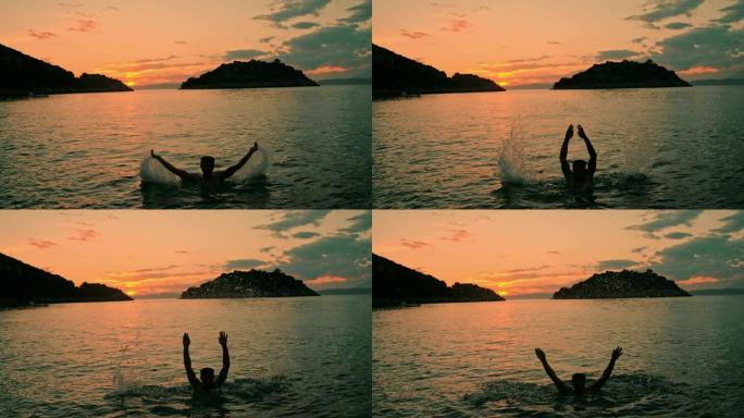 旺盛的男子女士在日落时跳出宁静的海洋，克罗地亚佩列萨克