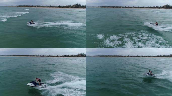 4k空中特写侧视图，男子在莫桑比克海洋中的个人船只上跳过海浪