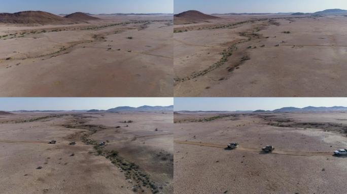 4x4车辆驶过纳米比亚纳米布沙漠的4k鸟瞰图