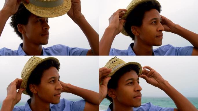海滩上戴着帽子的非洲裔美国人男子的前视图4k