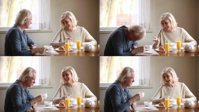 老年迷人夫妇吃健康早餐笑得开心