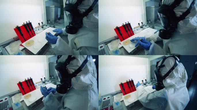 身穿危险品套装的实验室工作人员正在进行生化测试