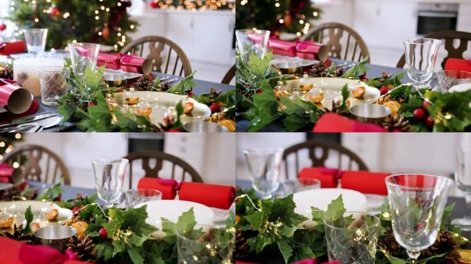 为圣诞节晚餐准备的餐桌，带有圣诞树和厨房背景，相机沿着桌子平移