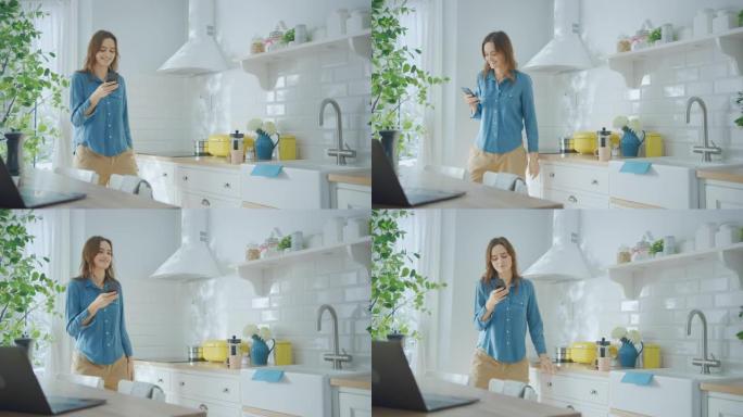 穿着牛仔裤衬衫和棕色裤子的年轻女性正在厨房里使用她的智能手机。她在现代厨房里跳舞，生活方式健康。快乐