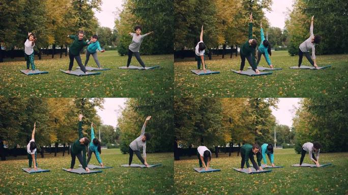 穿着运动服的年轻女士正在公园里锻炼，在绿色和黄色草地上的垫子上做瑜伽。健康的生活方式，现代的青年和秋