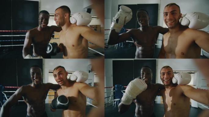 两名不同种族的年轻肌肉发达的男性拳击手的慢动作在拳击场上进行友好战斗后进行自拍照