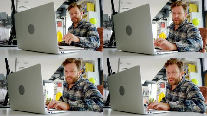 男性建筑师在4k办公桌上使用笔记本电脑