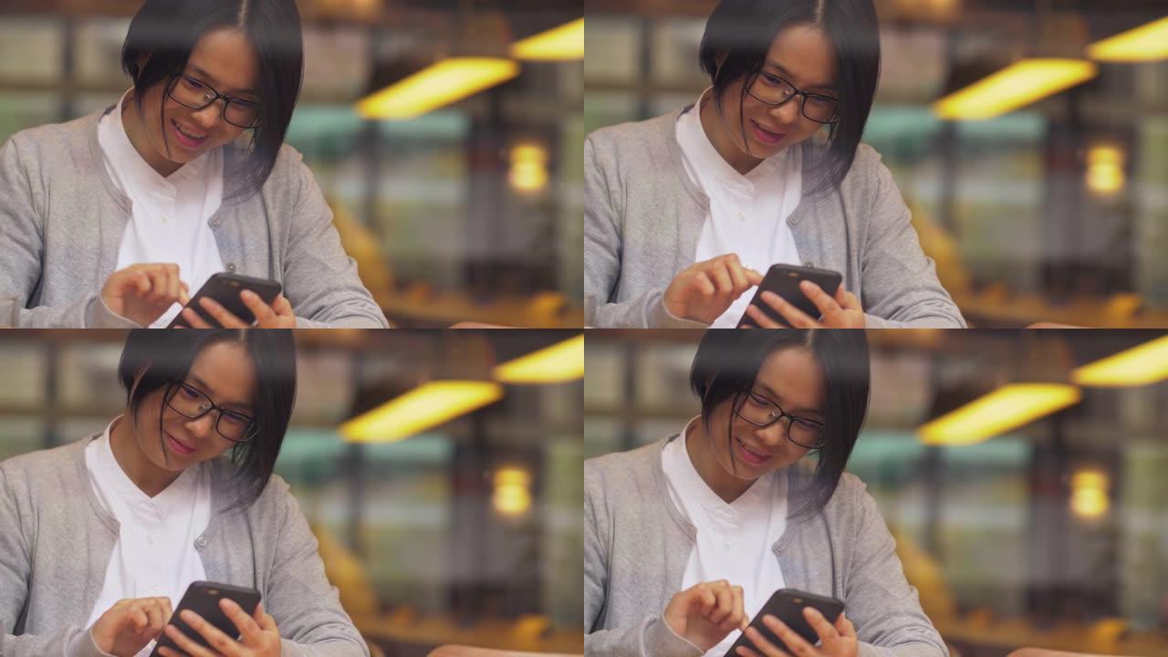 美丽的中国女人正在使用手机