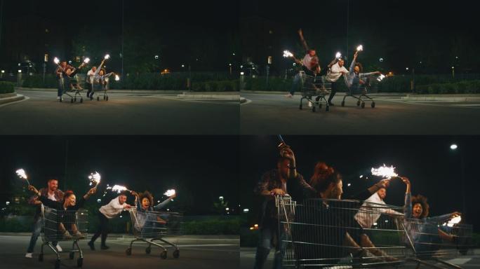 一群不同种族的年轻朋友的慢动作在晚上在超市停车场的购物车上一起玩耍