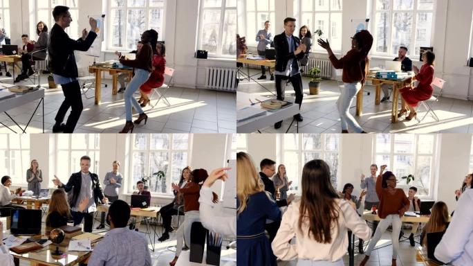 快乐的多民族办公室公司经理在现代健康的工作场所派对上做有趣的疯狂舞蹈，庆祝成功。
