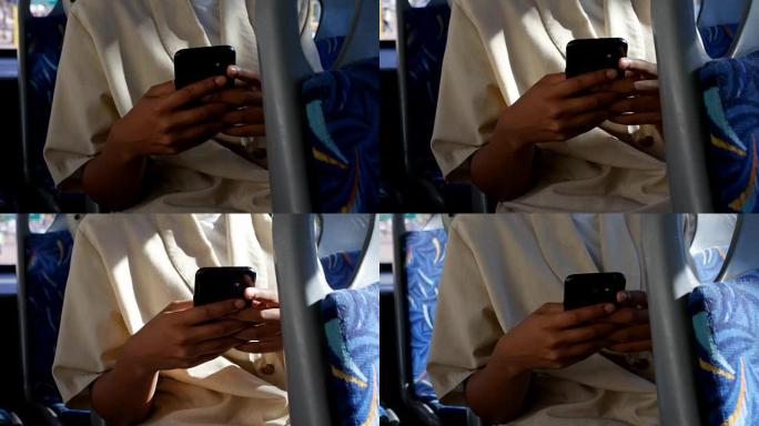 乘坐公交车4k时使用手机的女性通勤者