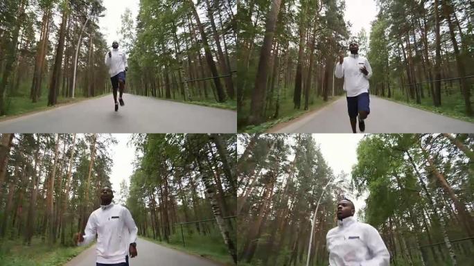 男跑者沿着森林路慢跑