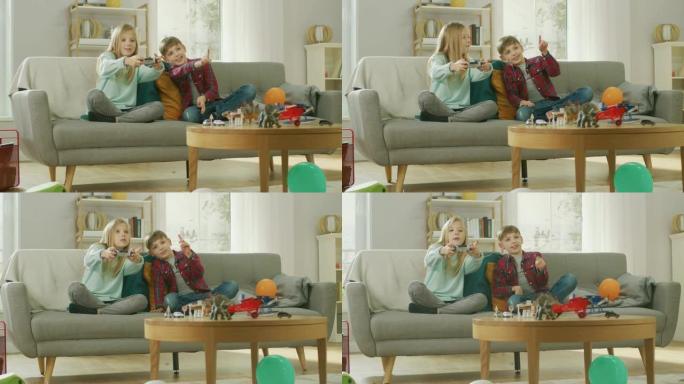 在家: 可爱的女孩在视频游戏机中玩耍，使用操纵杆控制器，她的年轻兄弟为她欢呼。玩电子游戏的快乐孩子。