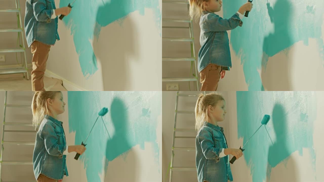 穿着牛仔裤外套的可爱的小女孩正在粉刷墙壁。她用覆盖着浅蓝色油漆的滚筒绘画。家里的房间装修。