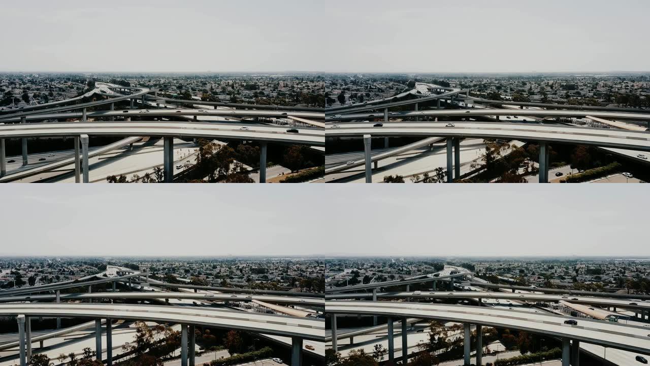 无人机在洛杉矶的大型高速公路交界处向右移动，汽车穿过多个道路。