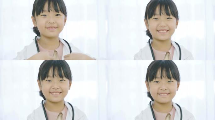 穿着白大褂的年轻小女孩医生的肖像，听诊器看着相机。