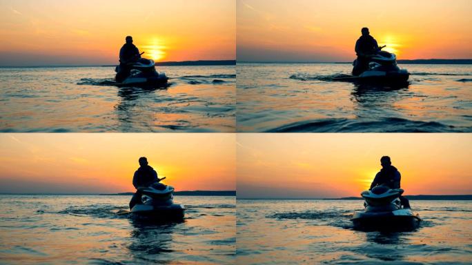 骑手坐在日落背景上的摩托艇上，近距离拍摄。