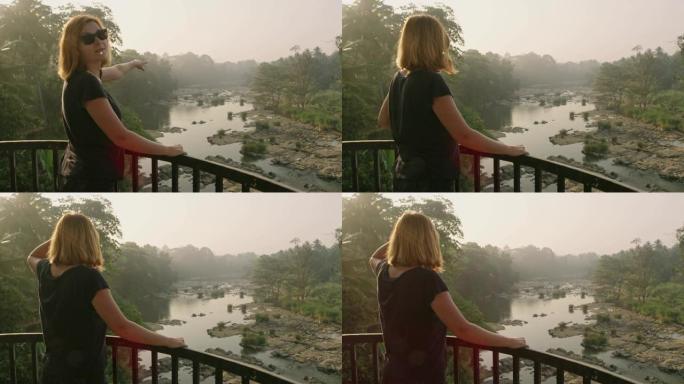 女士在阳台上看着斯里兰卡宁静的河景