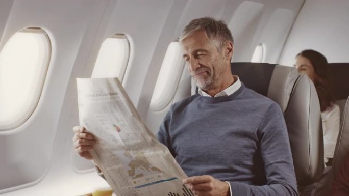 自信的商人在喷气机上阅读报纸