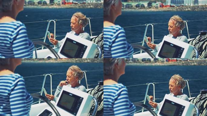 高级男子在女子驾驶游艇时使用电话