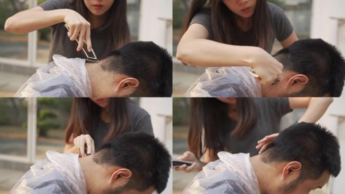 在新型冠状病毒肺炎电晕病毒的情况下，用理发推子从男人脖子上剃掉柔软的头发，帮助拉平曲线