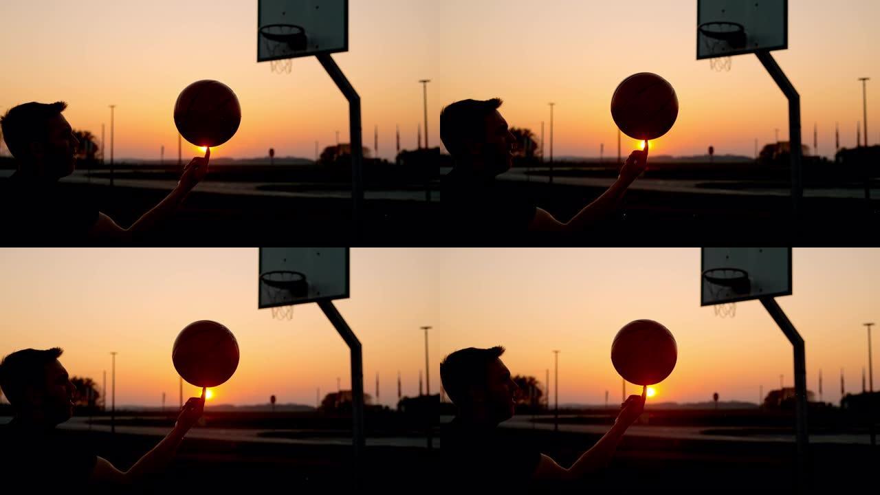 MS超级慢动作男子在日落时在室外篮球场上旋转篮球
