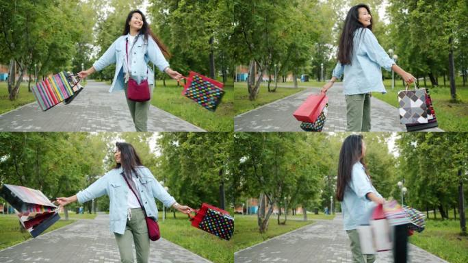 快乐的亚洲女孩在公园里旋转，拿着购物袋玩得开心