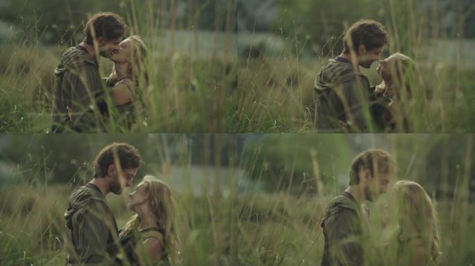 夫妇在高草丛中拥抱。日落